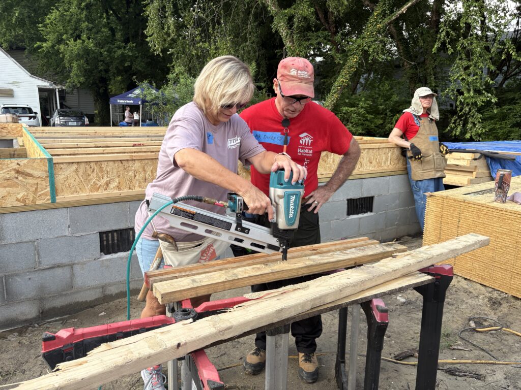 Woman using pneumatic nailing tool